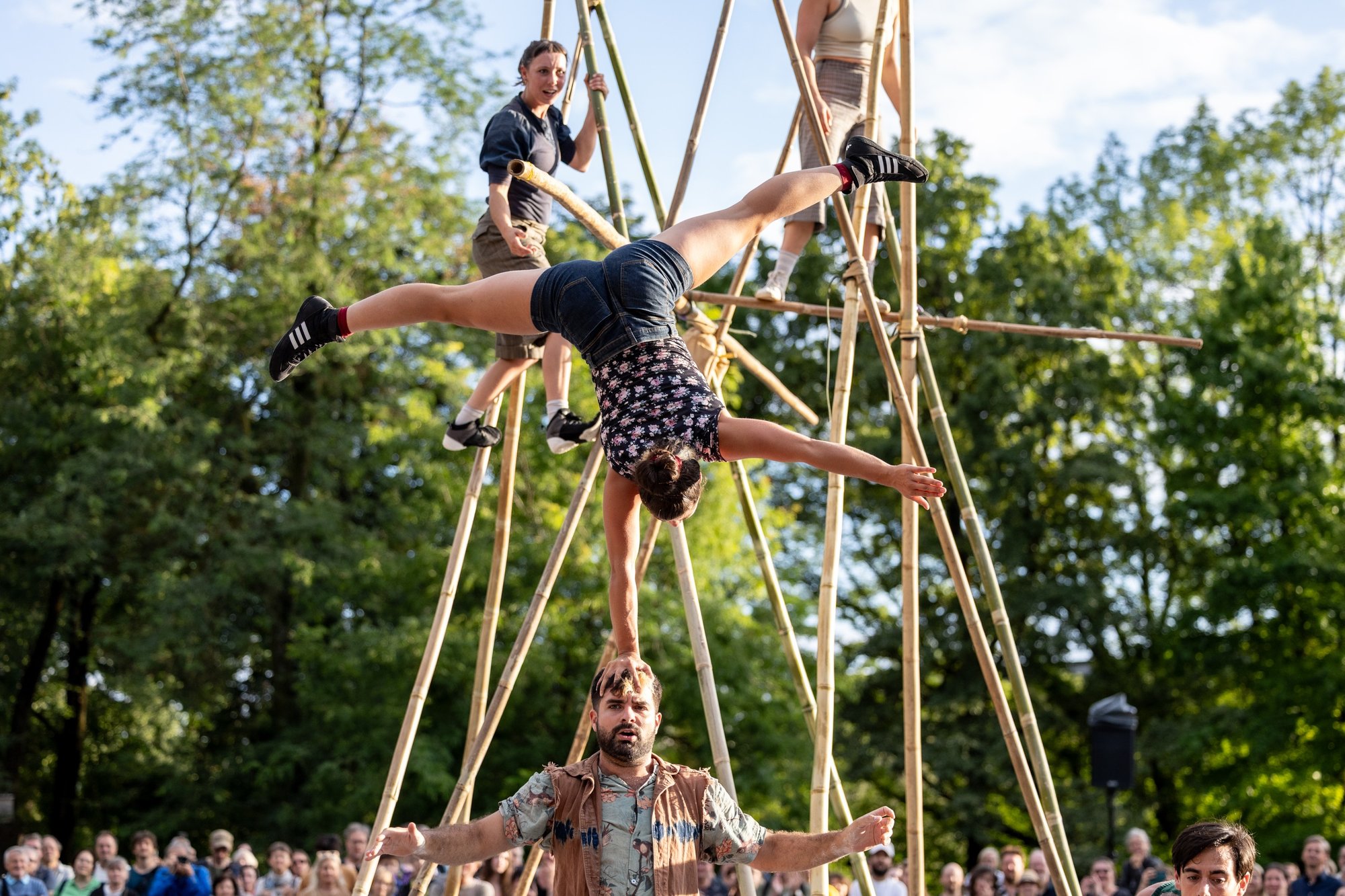 An acrobat balancing on a mans head
