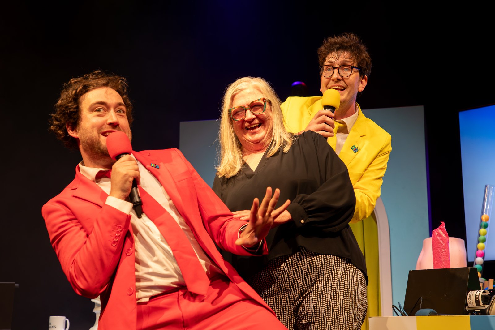 Three people dancing and singing
